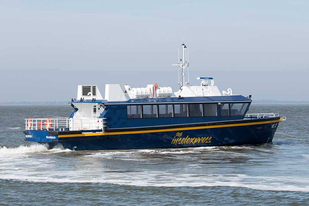 Fast ferry Insel Express 2 sailing on the Wadden Sea near Norddeich
