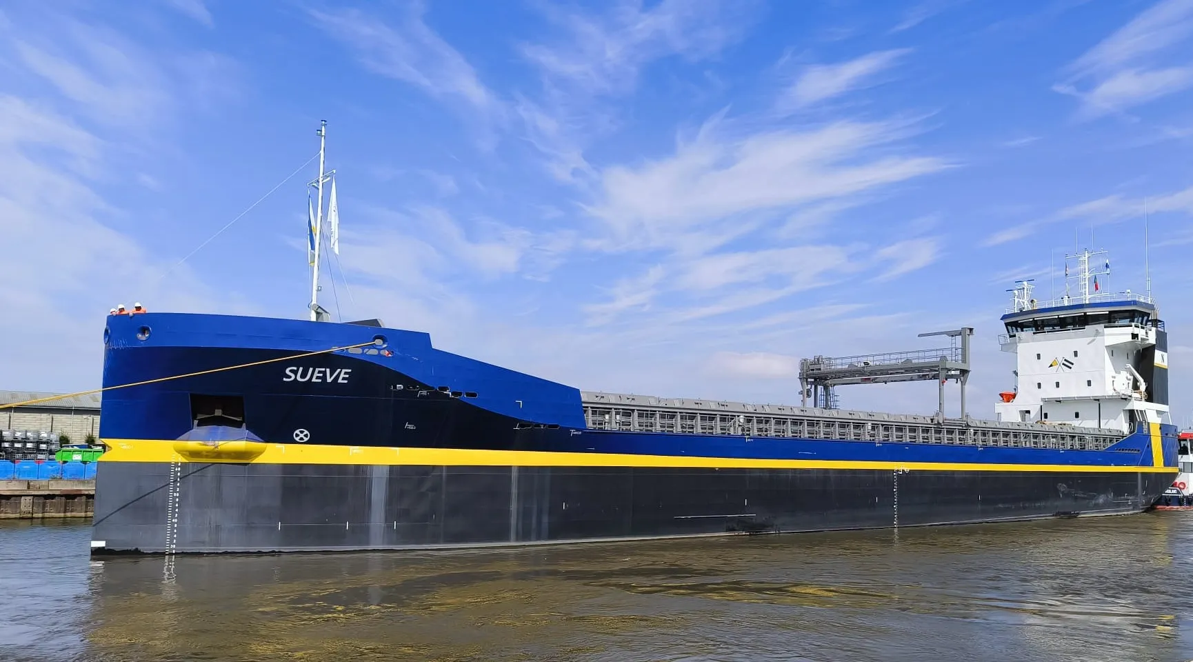 Blue general cargo vessel Sueve moored alongside the quay